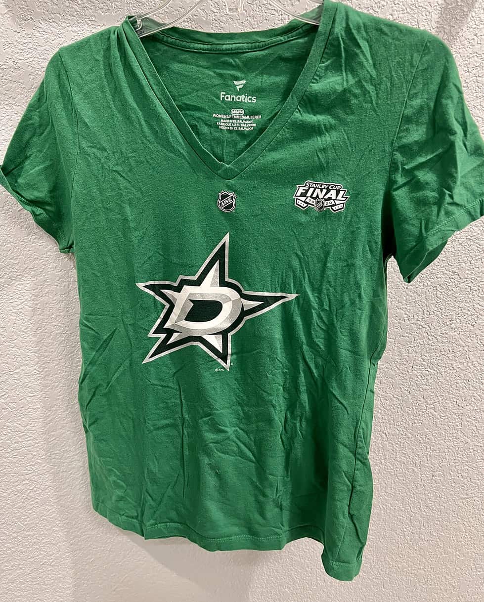 Front view of a Dallas Stars women’s v-neck tee in vibrant green, featuring the large Dallas Stars logo and the 2020 Stanley Cup Finals emblem.
