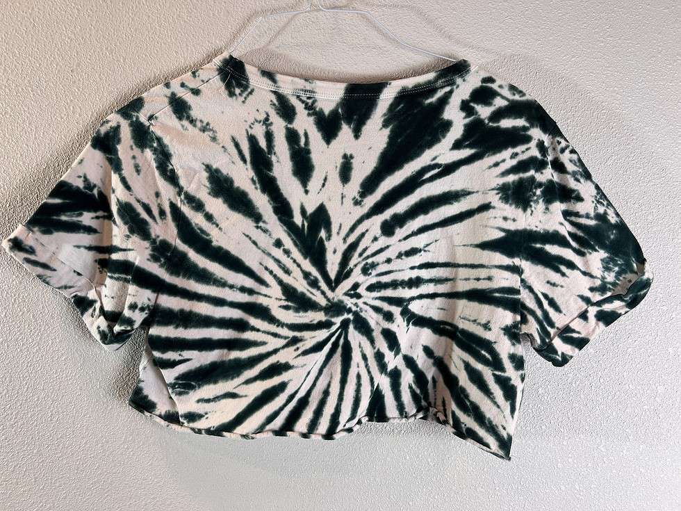 Back view of the cropped tie-dye t-shirt, showcasing the dynamic spiral pattern typical of the tie-dye technique.
