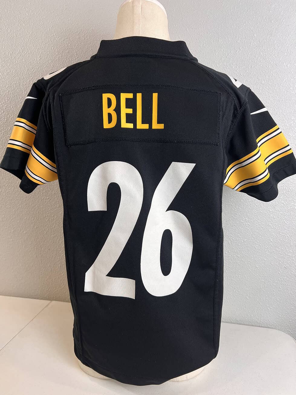 Back view of the Steelers #26 jersey with 'BELL' printed above the large white number, representing former player Le'Veon Bell.