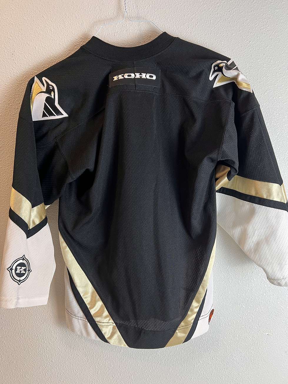 Back view of the Pittsburgh Penguins logo on the jersey, showcasing the embroidered patch with a penguin holding a hockey stick. No numbers.