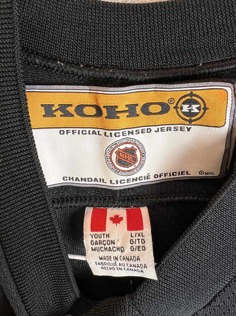 Tag inside the Pittsburgh Penguins jersey with the Koho brand logo, size marked as Youth L/XL, and 'Made in Canada' label