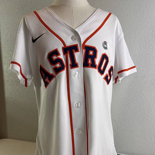 Front view of a new, with tags, women’s XL Houston Astros baseball jersey by Nike, featuring the team name in bold letters.