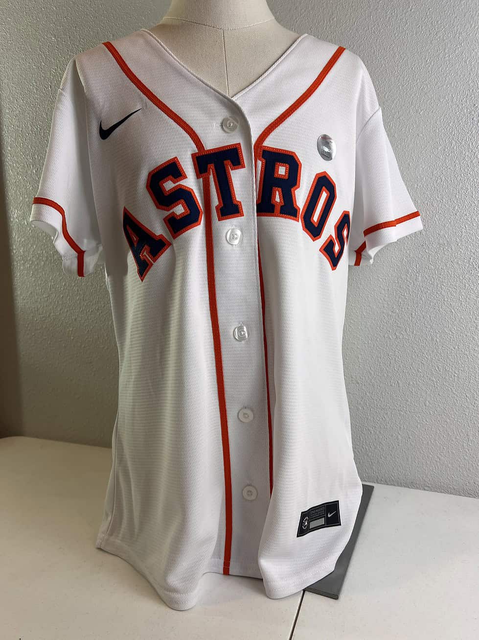 Front view of a new, with tags, women’s XL Houston Astros baseball jersey by Nike, featuring the team name in bold letters.