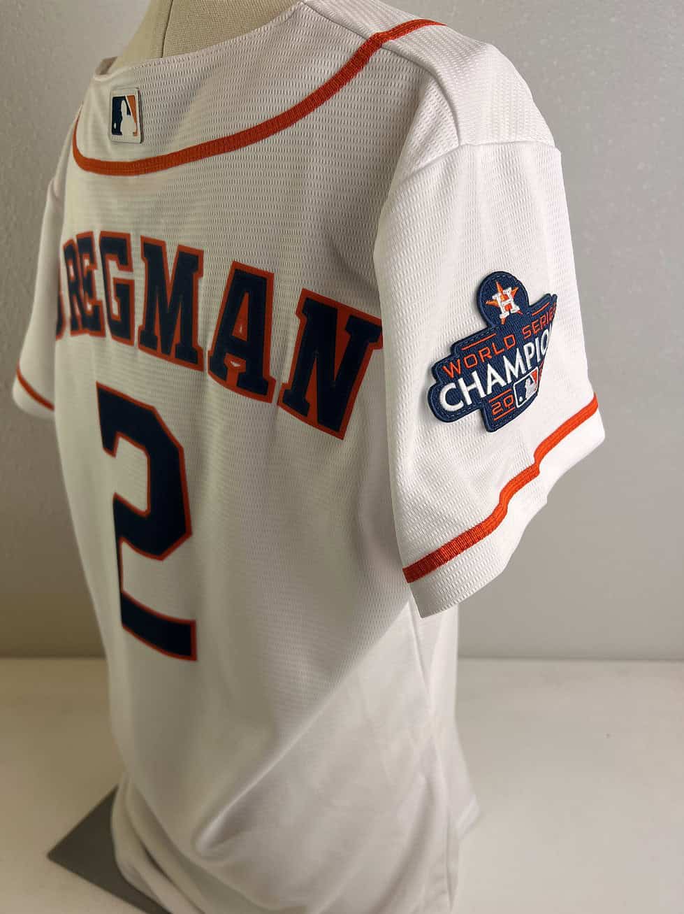 Back view of the Astros jersey with ‘BREGMAN’ and his number ‘2’ emblazoned in navy, outlined in orange, with a World Series 2022 patch on the sleeve.