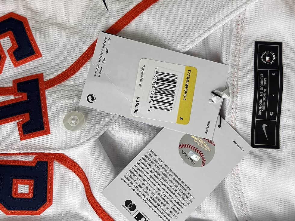 Close-up of the jersey tags showing Nike branding, size S, with a suggested retail price and a barcode.