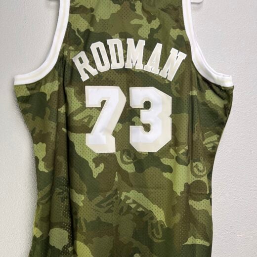 Back view of the camo Lakers jersey with 'RODMAN 73' in white lettering.