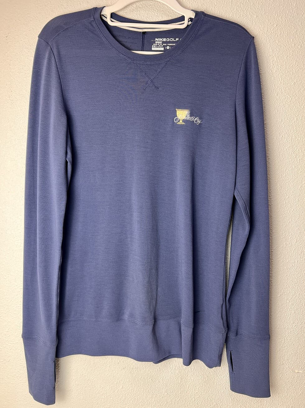 Blue Nike Golf long-sleeve pullover with Presidents Cup 2013 logo on the front.