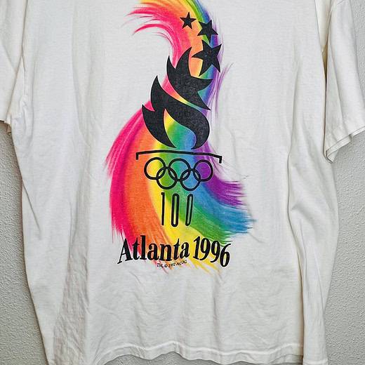 Front view of vintage Atlanta 1996 Olympics tee with rainbow flame design under the Olympics torch and rings logo.