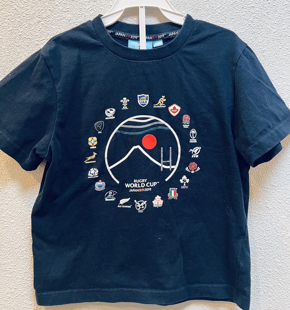 Front view of Rugby World Cup Japan 2019 kids t-shirt. International rugby association logos are displayed in a circle on the front, with the 2019 logo in the middle.