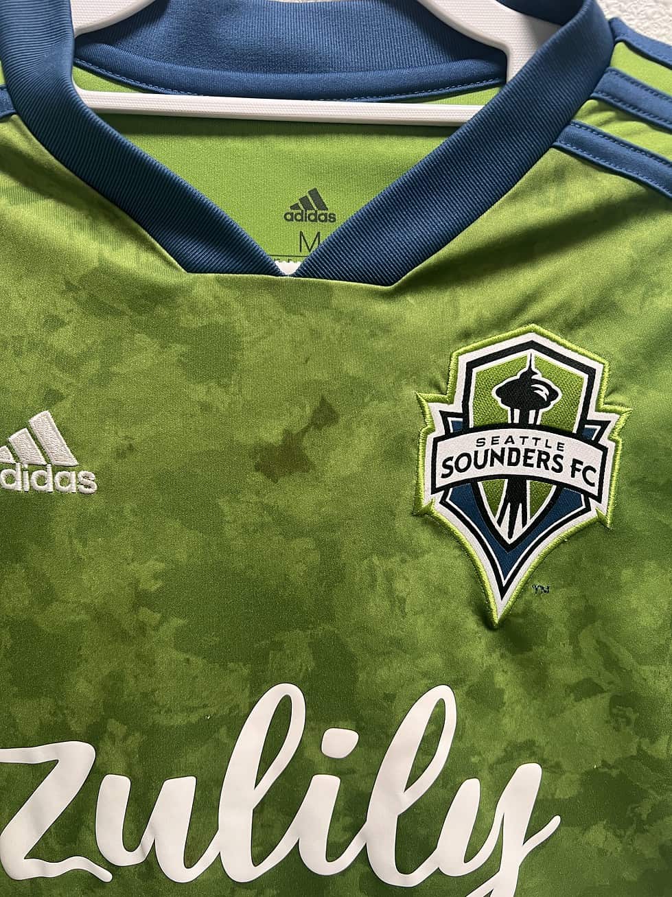 Close-up of Seattle Sounders FC crest and Zulily logo on 2019-2020 youth jersey
