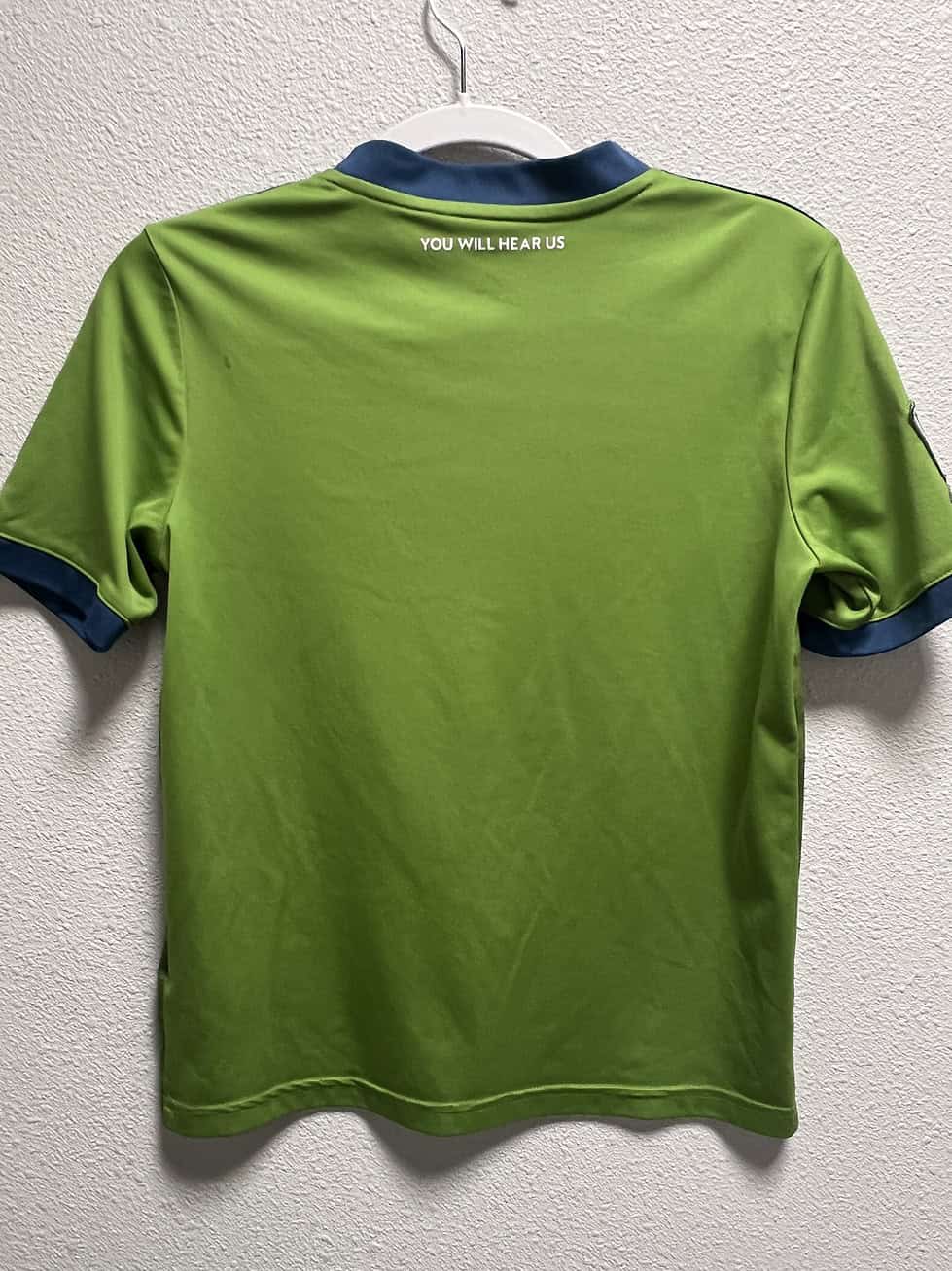 Back view of Seattle Sounders FC 2019-2020 youth jersey with 'You Will Hear Us' slogan
