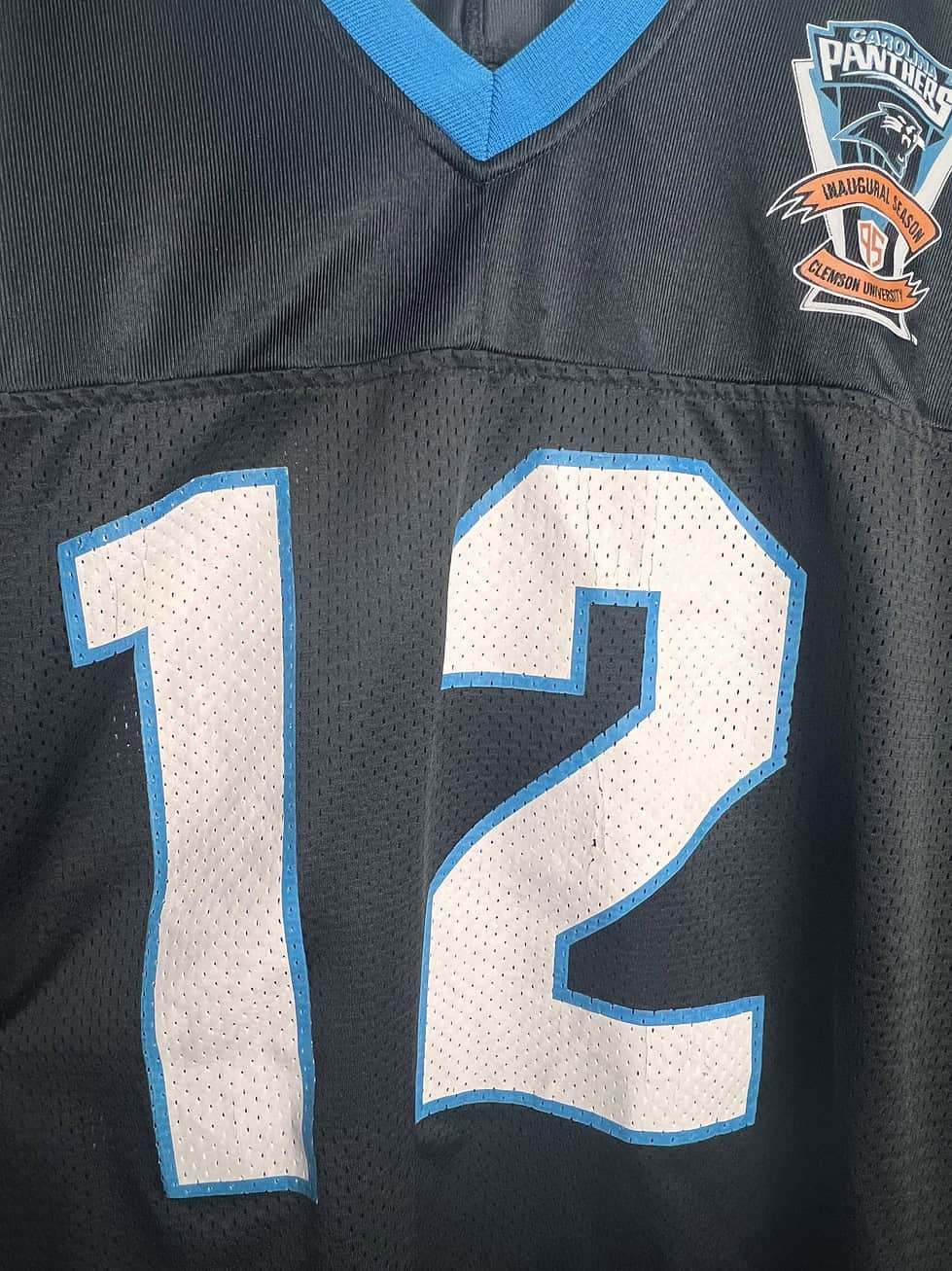 Closeup of number 12 in jersey lettering showing few cracks in the print.