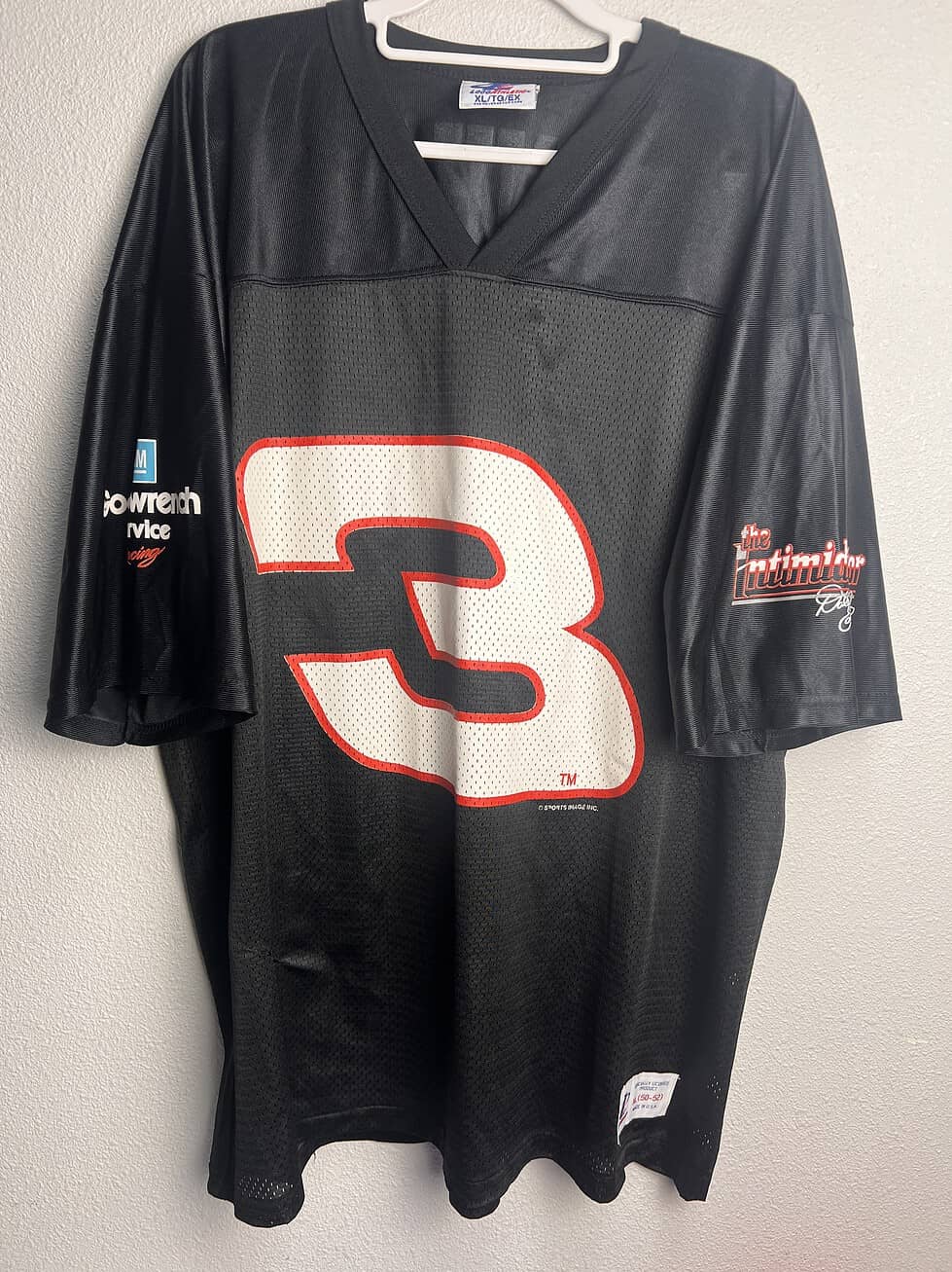 Vintage black Dale Earnhardt Sr. NASCAR Jersey featuring the number 3 on the front, displayed on a hanger.