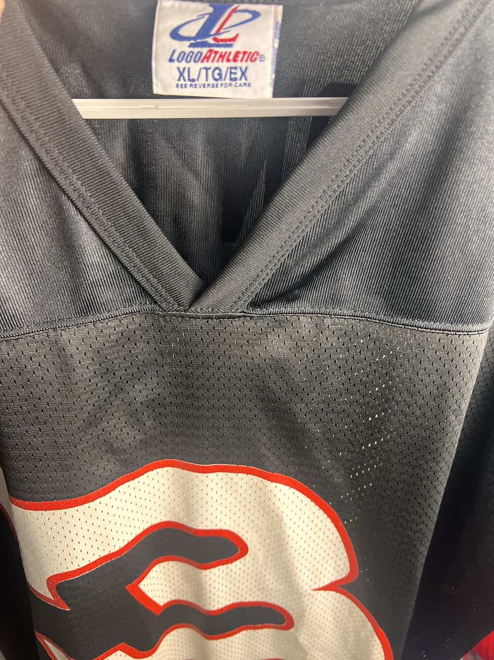 Close-up of the Logo Athletic tag on the Dale Earnhardt Sr. NASCAR Jersey, showing XL