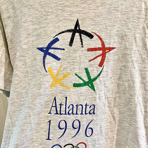 Detailed view of the Atlanta 1996 Olympics logo on vintage T-shirt.