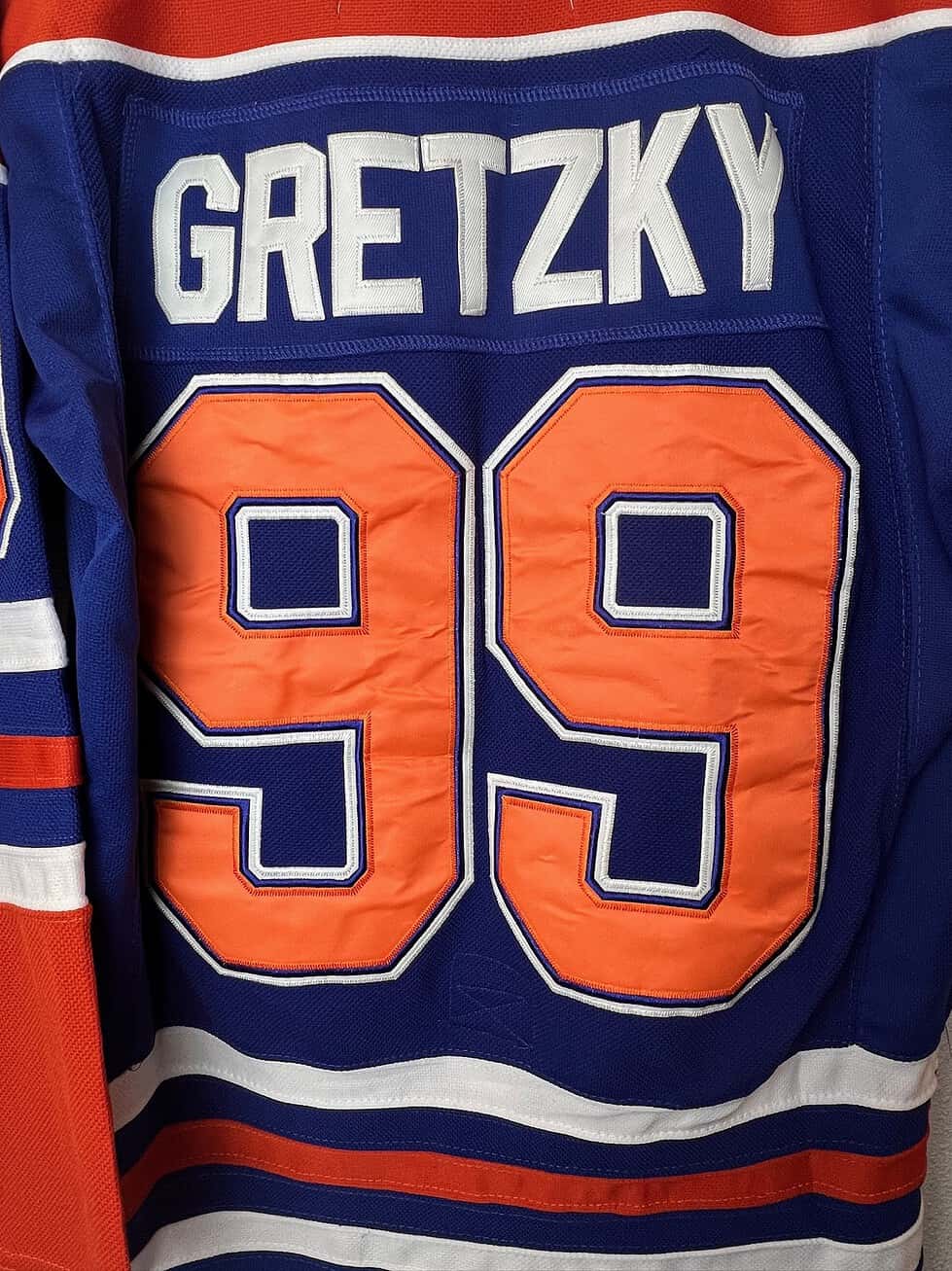 Close-up of the back of a Wayne Gretzky Edmonton Oilers jersey showing the CCM logo and detailed stitching.