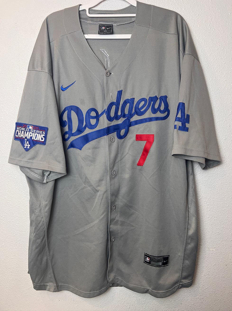 Front view of a gray Los Angeles Dodgers Nike jersey featuring Julio Urías’ number 7, with a 2020 World Series Champions patch on the sleeve.