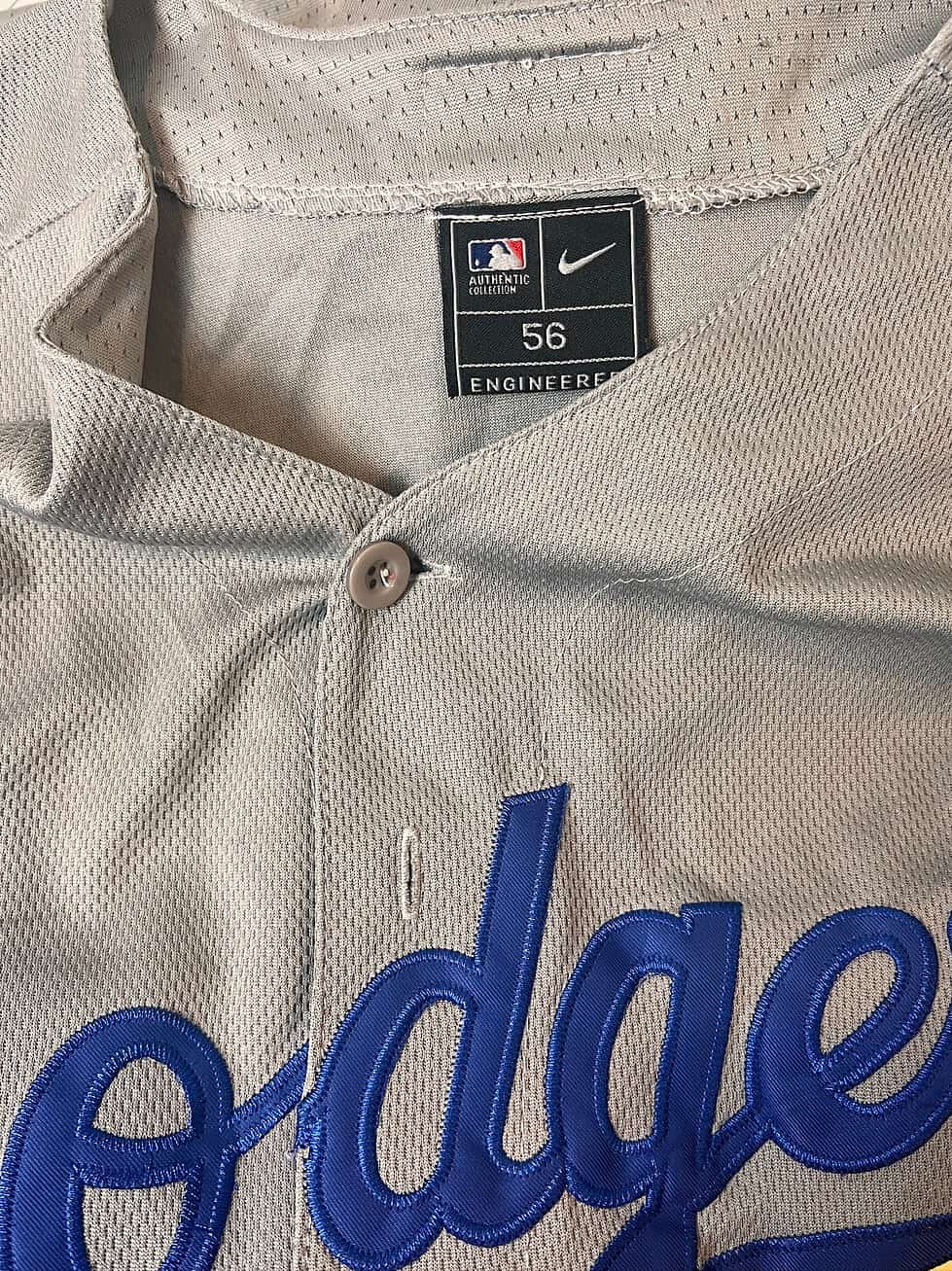 Close-up of the missing second button on a Los Angeles Dodgers Nike jersey.