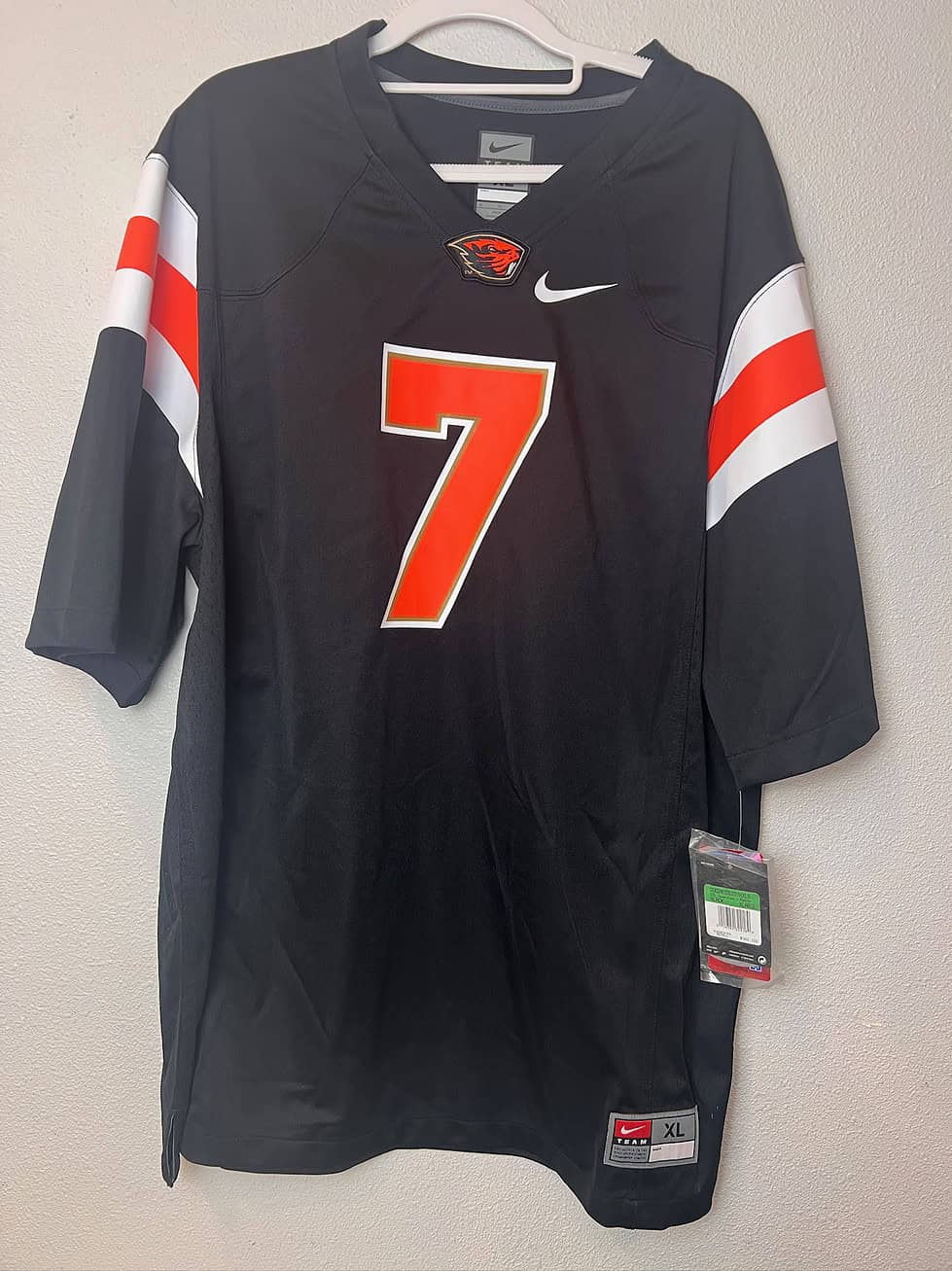 Front view of Oregon State Beavers #7 black Nike replica jersey, size XL, with orange and white accents, new with tags.