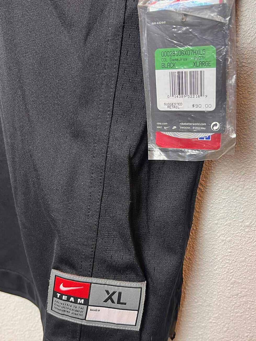 Close-up of the size tag and original retail tag on the Oregon State Beavers #7 Nike replica jersey, size XL.