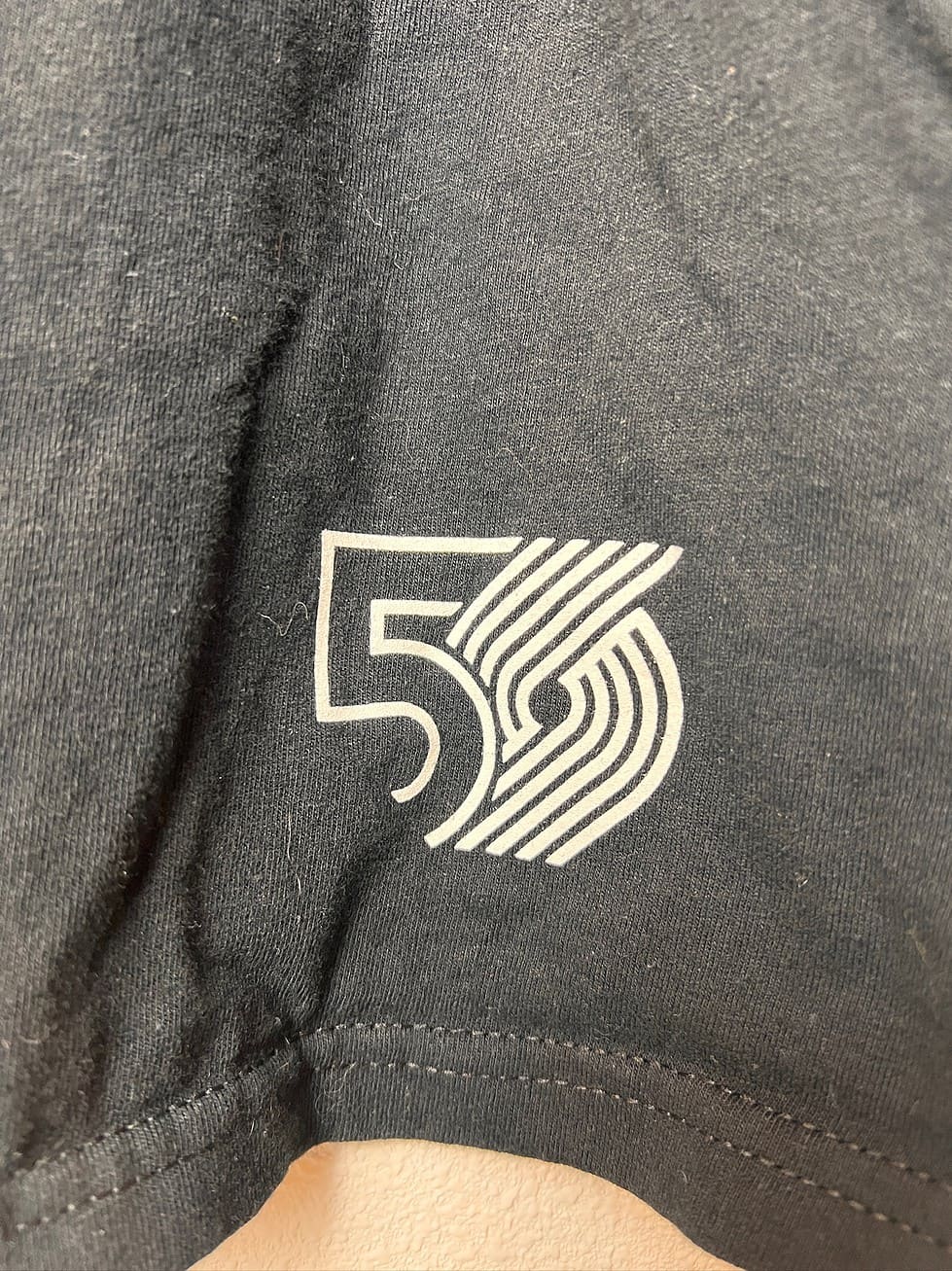 Logo of Trail Blazers shirt from the 2019-2020 50th anniversary season with red and white logo,