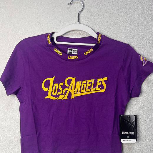 Front view of a purple Los Angeles Lakers women’s crop tee by New Era, size XS, featuring "Los Angeles" in gold lettering and Lakers branding on the collar.
