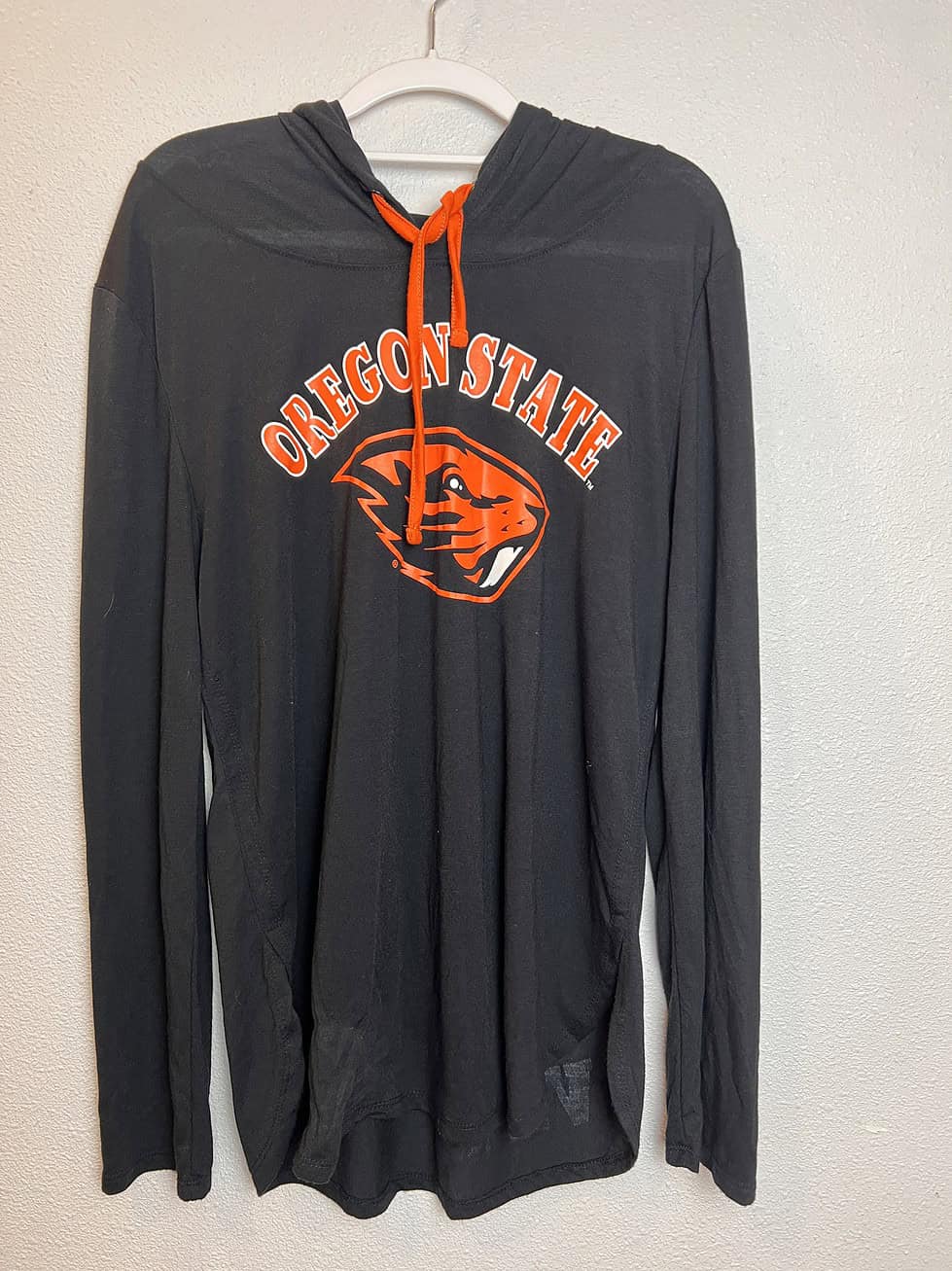 Full front view of hooded long sleeve, emphasizing its soft fabric and laid-back style.