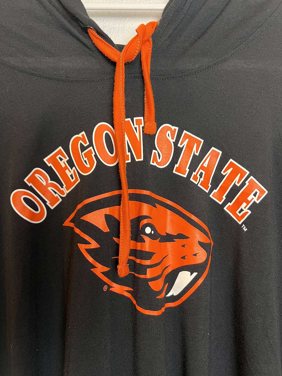 Front view of the hoodie showcasing Oregon State Beavers graphic with bright orange accents.