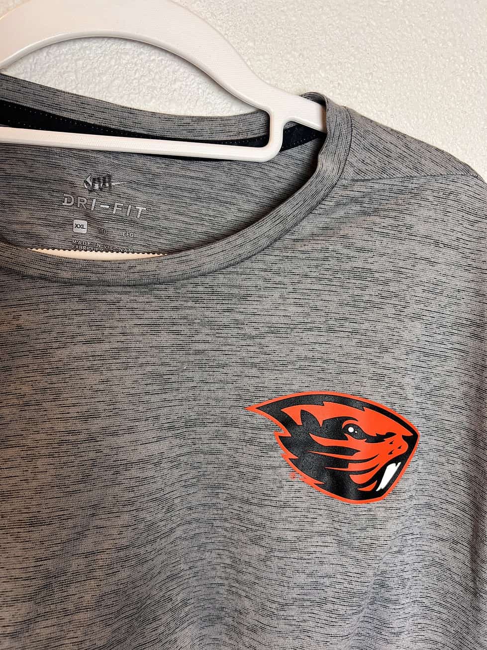 Close-up of Dri-FIT tag and Beavers logo on chest.