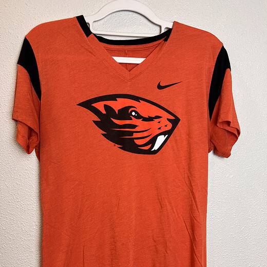 Front view of bright orange Nike Oregon State Beavers V-neck T-shirt with bold logo.