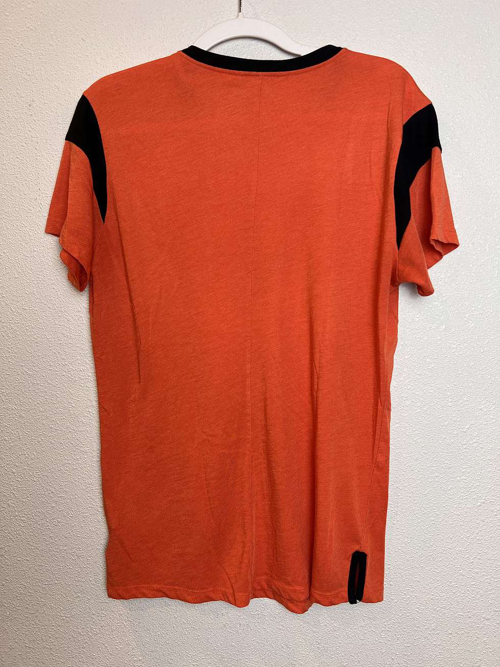 Back view showing black accents on the shoulders and breathable fabric.