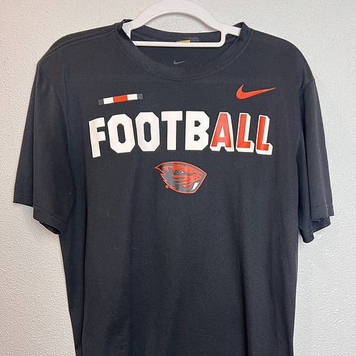 Front view of black Nike Oregon State Football T-shirt with bold graphics.