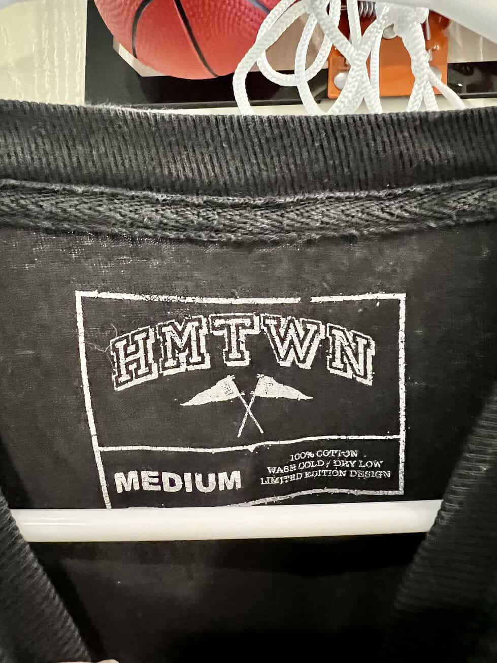 Close-up of Hometown (HMTWN) label inside the t-shirt, showing the Medium size and limited edition status.