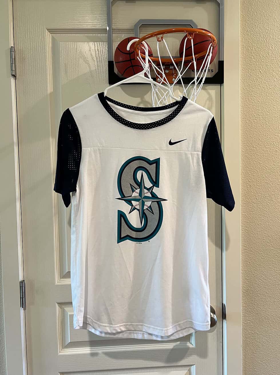 Front view of Seattle Mariners Nike T-Shirt featuring the classic team logo in teal and navy.