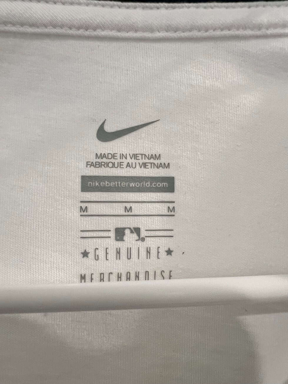 Close-up of size and Nike branding on Seattle Mariners T-Shirt, size Medium.