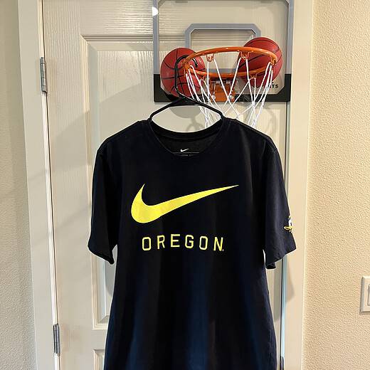 Front view of Oregon Ducks Nike T-Shirt with bold yellow Swoosh and “OREGON” text.