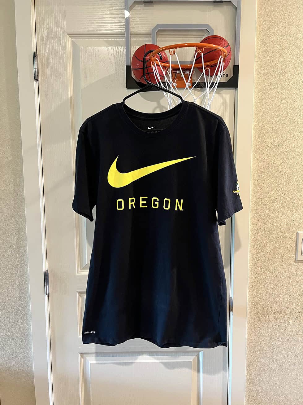 Front view of Oregon Ducks Nike T-Shirt with bold yellow Swoosh and “OREGON” text.