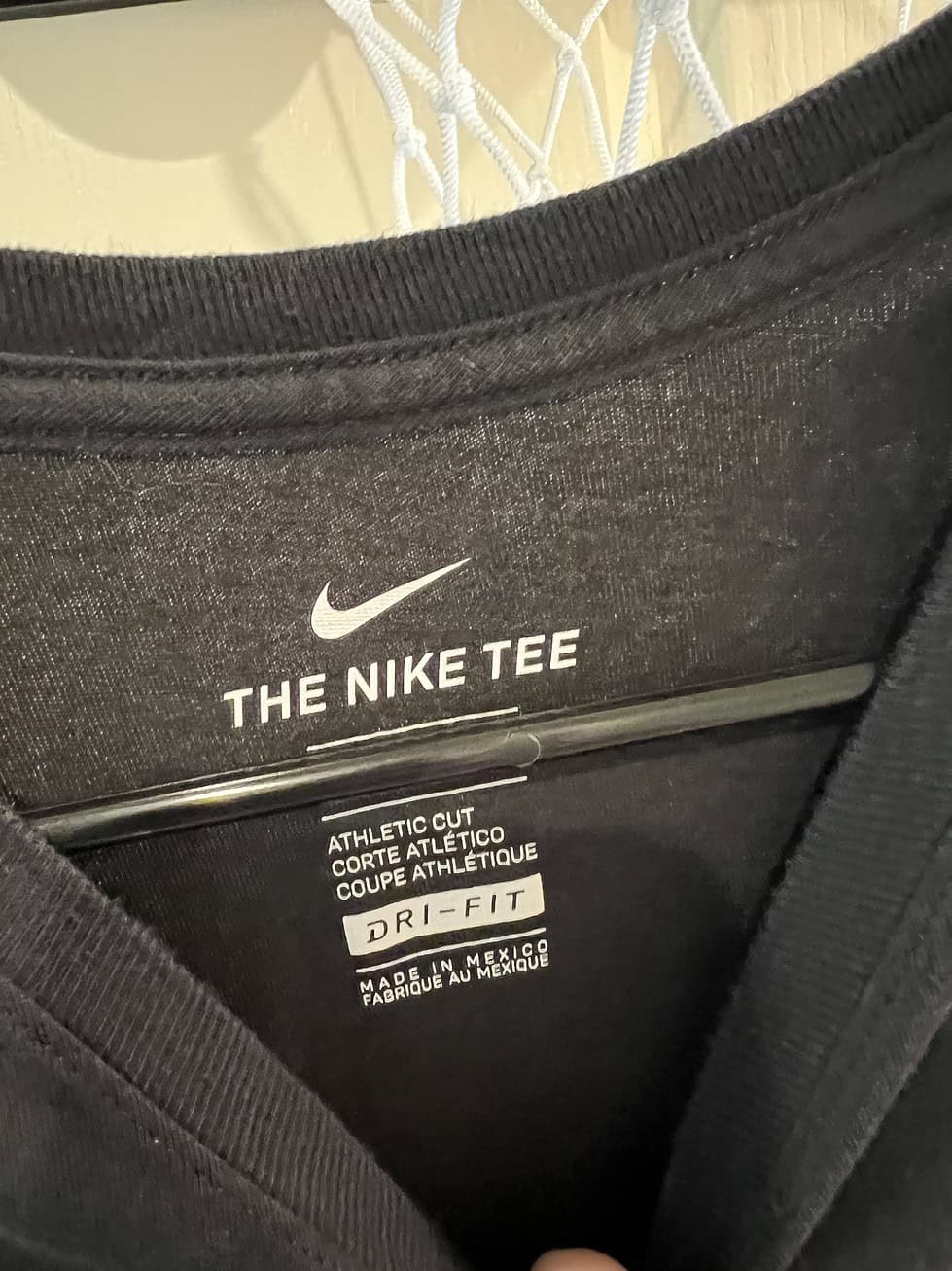 Close-up of Nike Dri-FIT label on Oregon Ducks T-Shirt, size Medium.