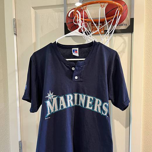 Front view of the vintage Seattle Mariners T-Shirt featuring the iconic team logo and henley-style button collar.