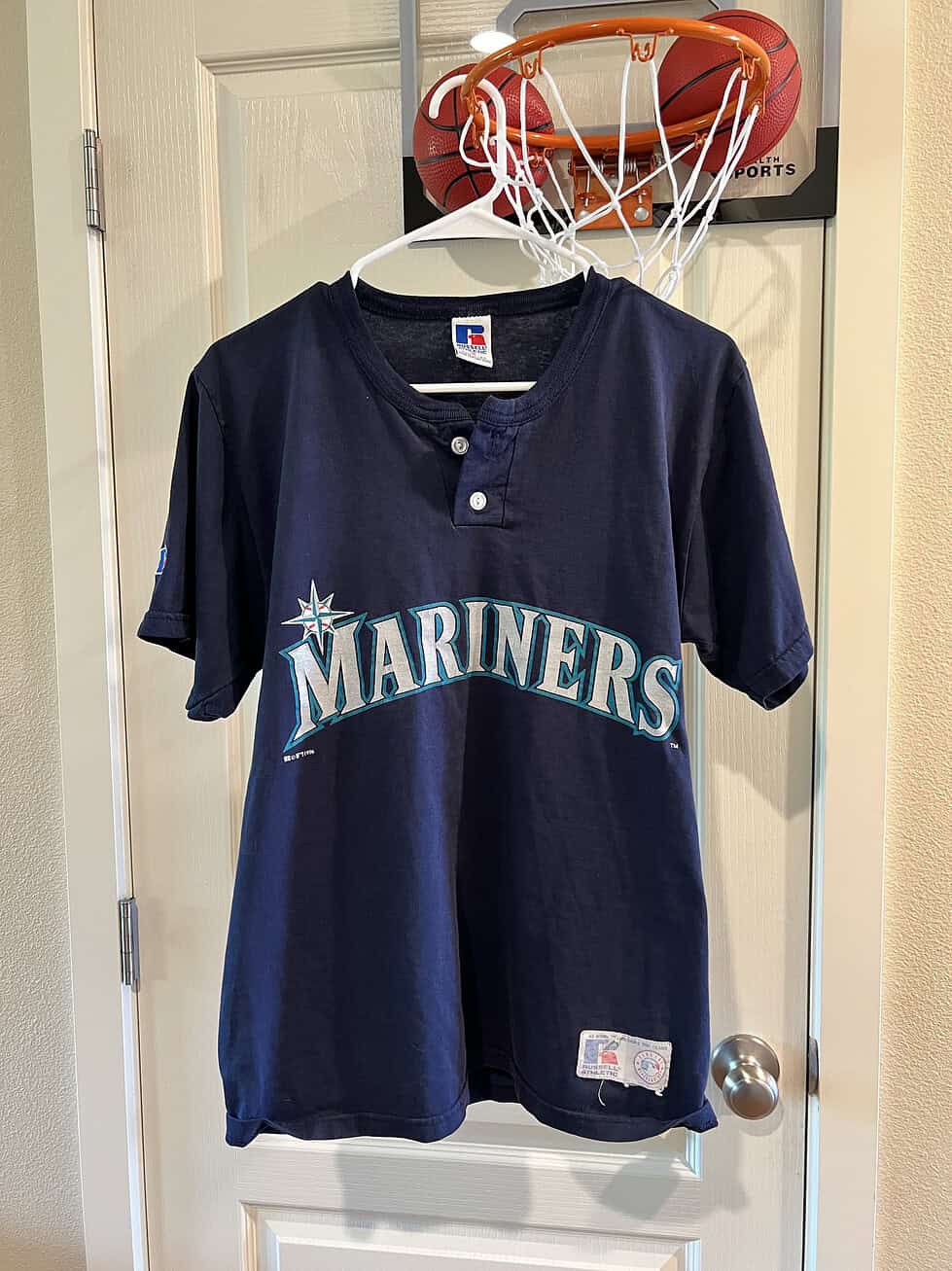 Front view of the vintage Seattle Mariners T-Shirt featuring the iconic team logo and henley-style button collar.
