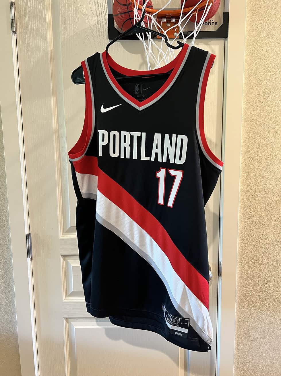 Front view of Portland Trail Blazers Jersey with “Portland” text and number 17 in red and white.