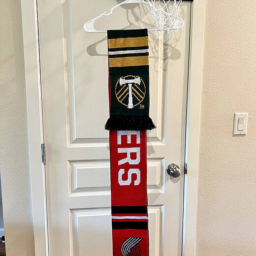 Reversible scarf showing both Portland Trail Blazers and Portland Timbers designs.