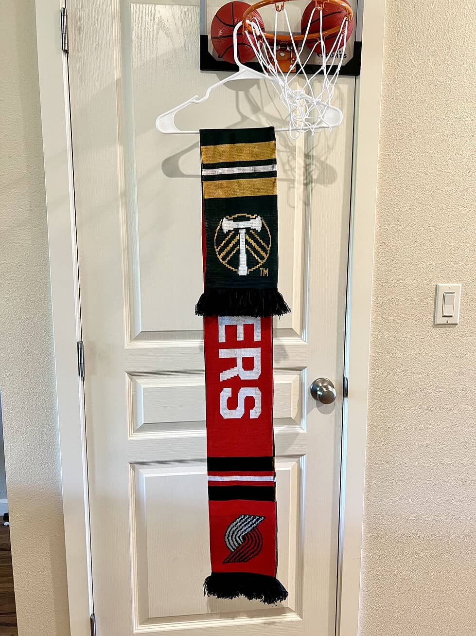 Reversible scarf showing both Portland Trail Blazers and Portland Timbers designs.