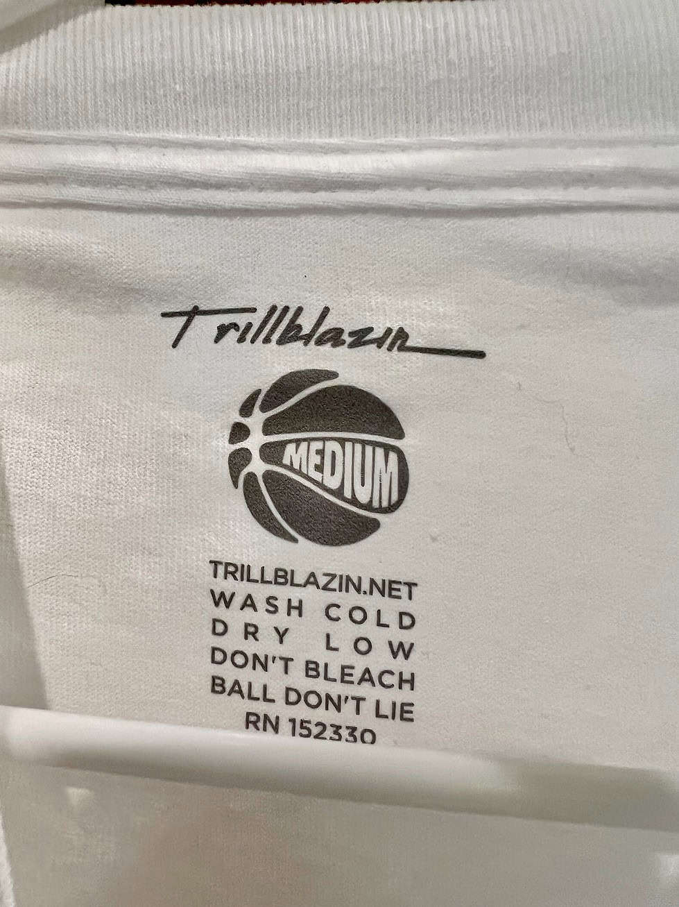 Close-up of Trillblazin label inside the t-shirt with care instructions.