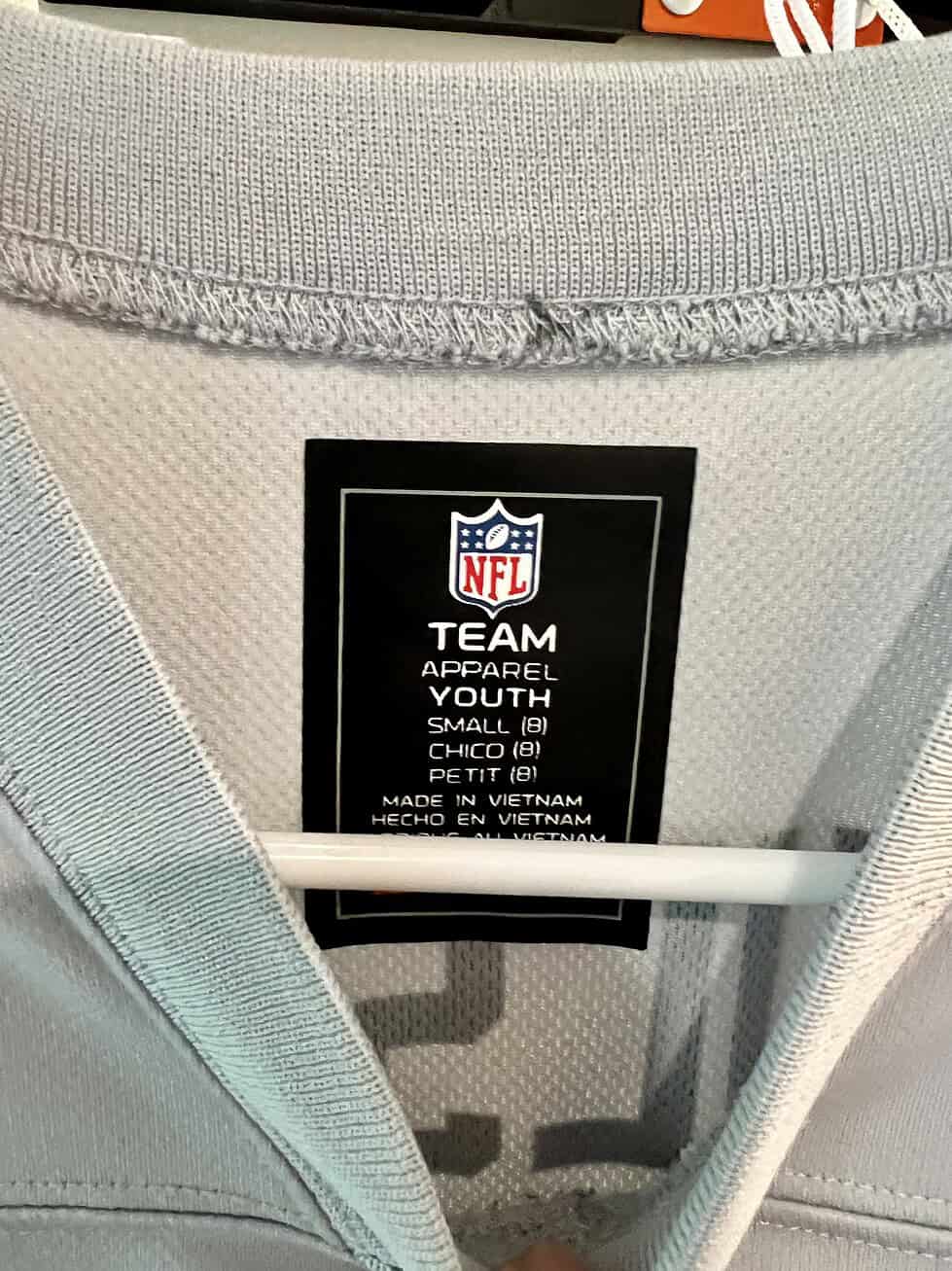 Close-up of NFL Team Apparel label on Russell Wilson Seattle Seahawks Youth Jersey, size Small.