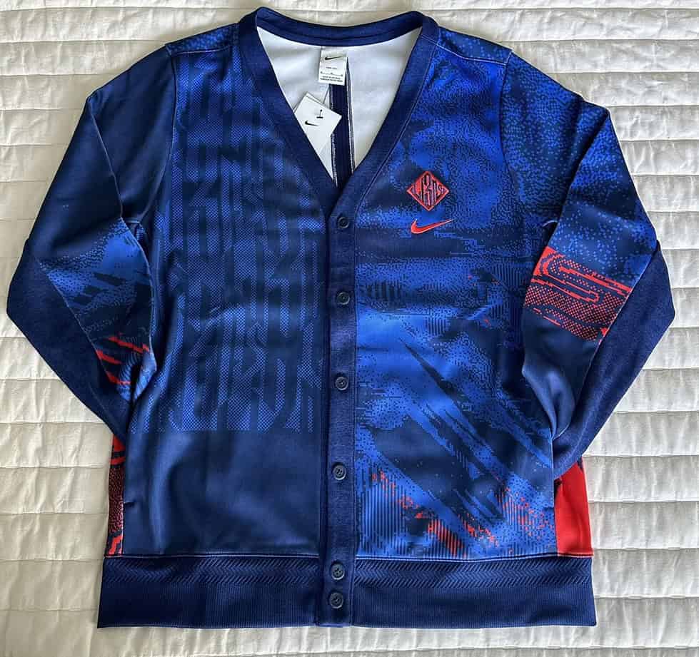 Front view of the Nike England Three Lions 2022 World Cup cardigan with bold red and blue graphics.