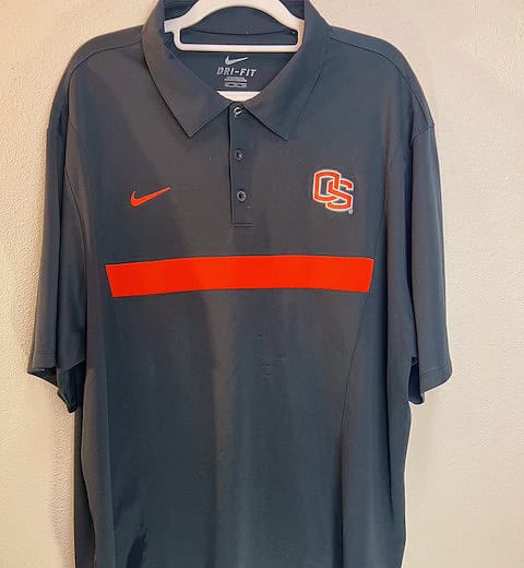 Front view of dark gray Nike Oregon State Beavers polo shirt, XXL, with OS logo and orange stripe across the chest.