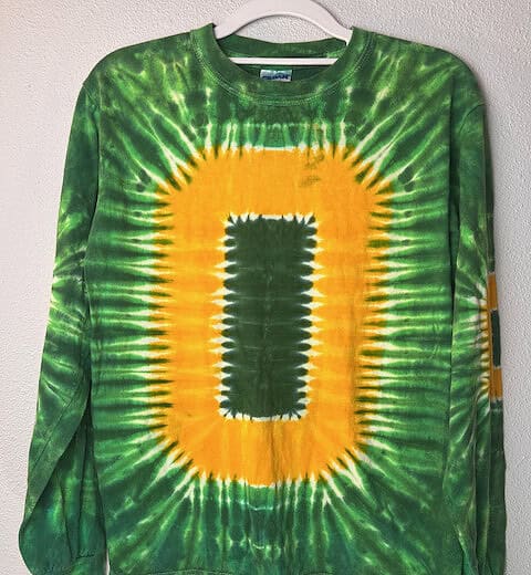 Front view of Gildan Oregon Ducks green tie-dye long-sleeve shirt with oversized “O” design.