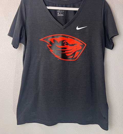 Front view of Nike Oregon State Beavers Dri-FIT V-neck shirt with "Angry Benny" logo.