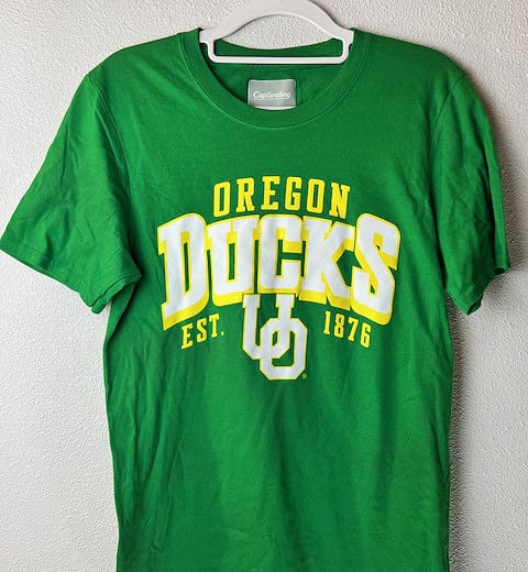 Front view of green Oregon Ducks tee with bold yellow and white lettering.